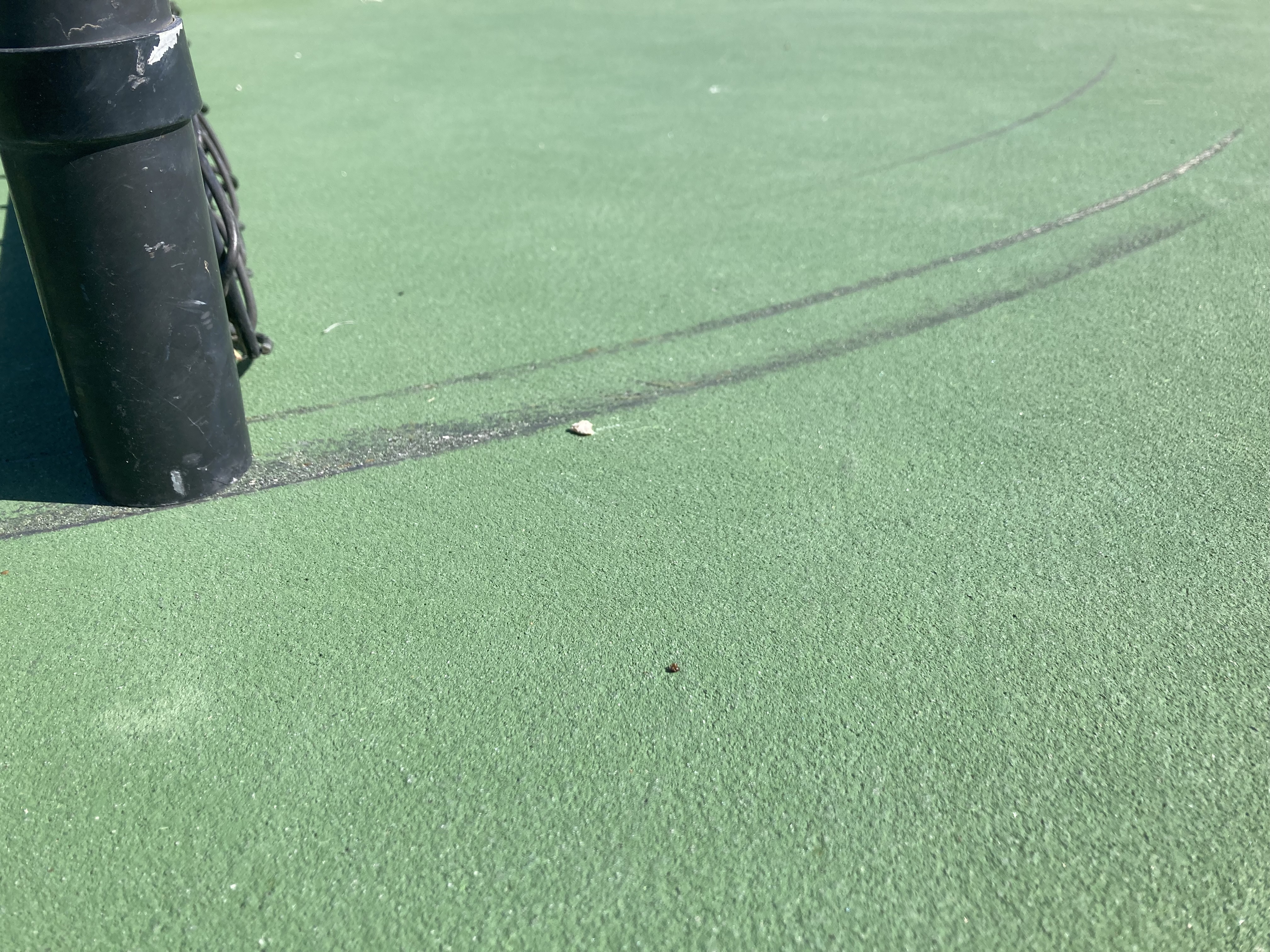 Close-up of deep black scrape marks ground into the court surface