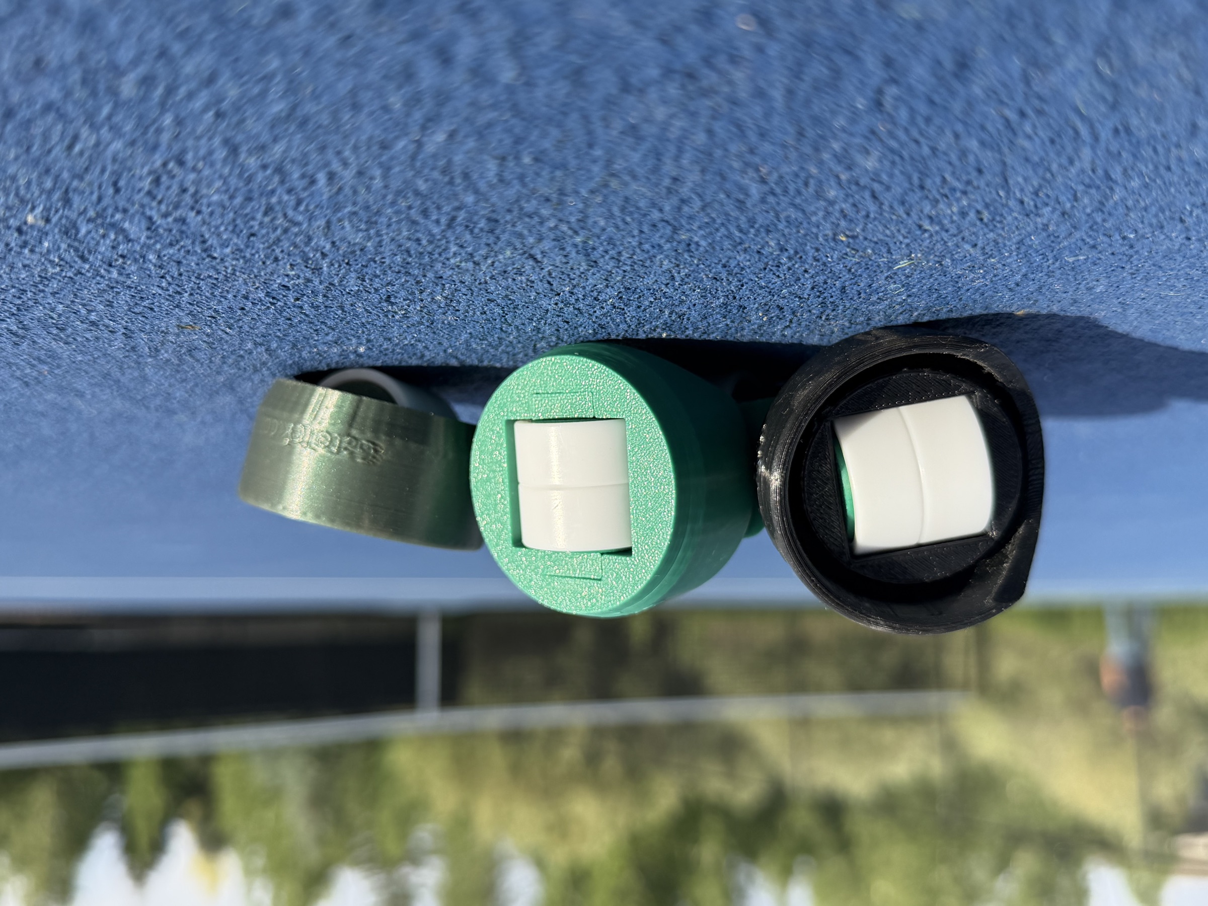 Two GateTek caps on the court, internal caster wheels visible